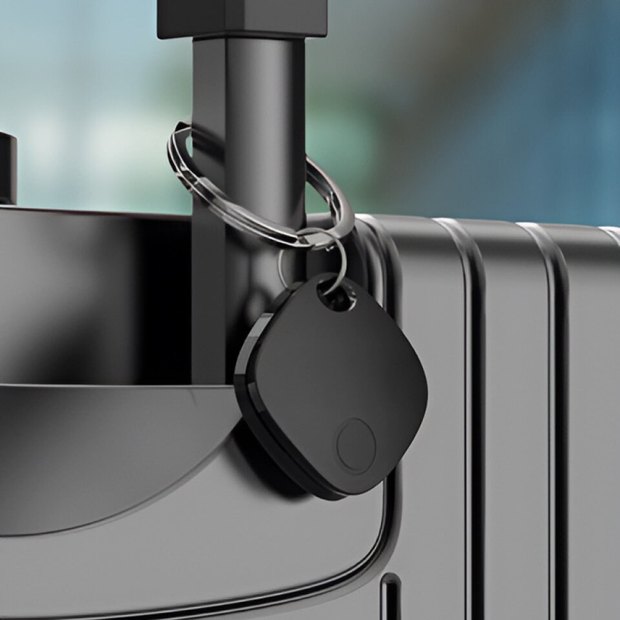 iTagPro clipped to a keyring on the handle of a suitcase