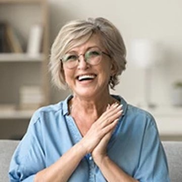 Portrait of a smiling woman, one of three review photographs published on the Nuvia checkout